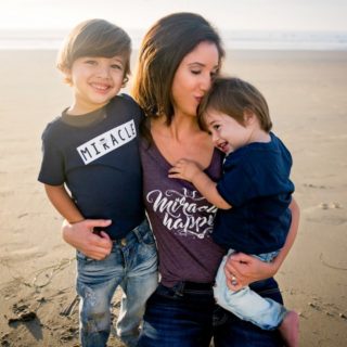 Nadine on beach with her 2 sons