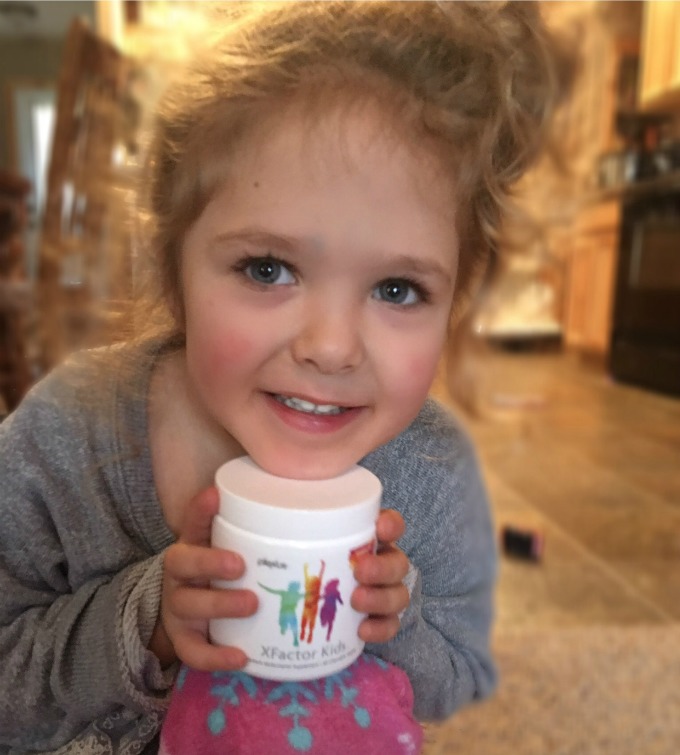 Ava holding a plexus bottle