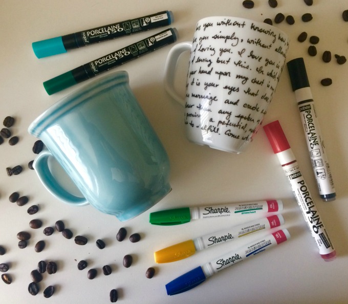 Mugs laying on a table with sharpies