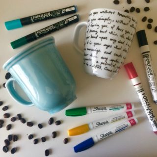 Mugs laying on a table with sharpies