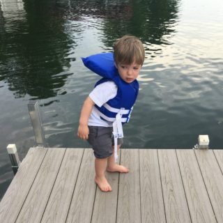 Eli standing on a dock.
