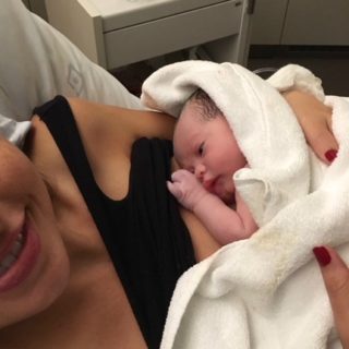 Stacie holding a newborn Audrey