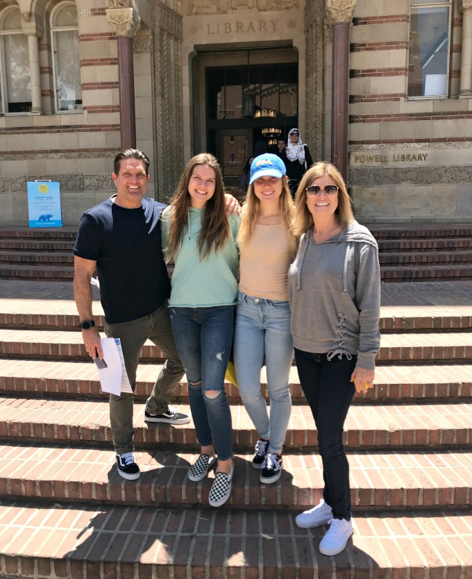 family standing on college library steps