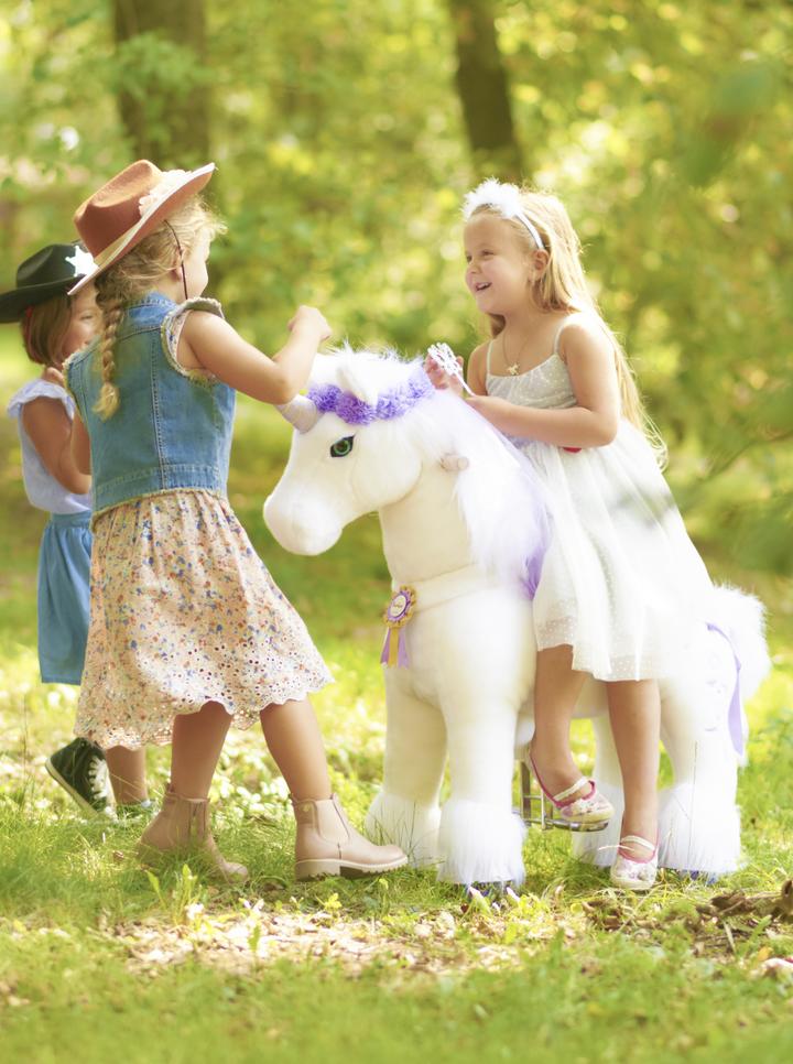 girls playing with unicorn ponycycle