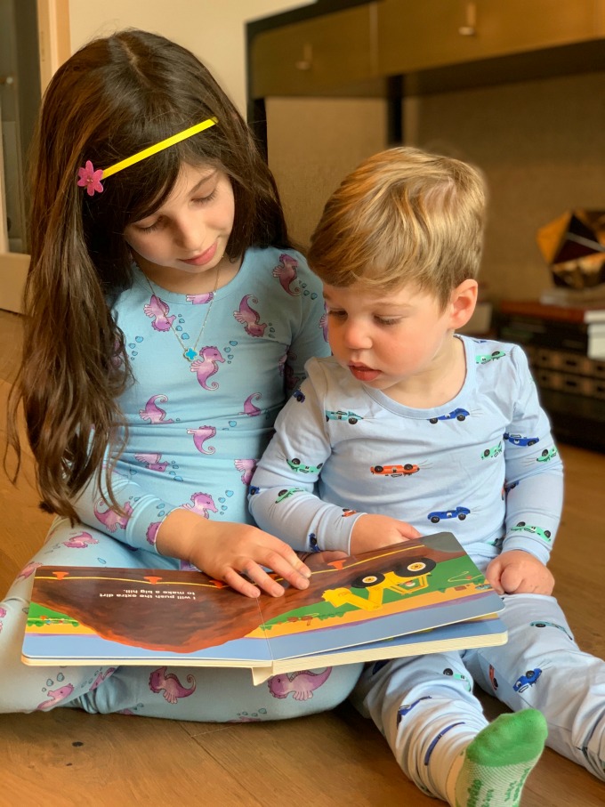 two kids reading a book