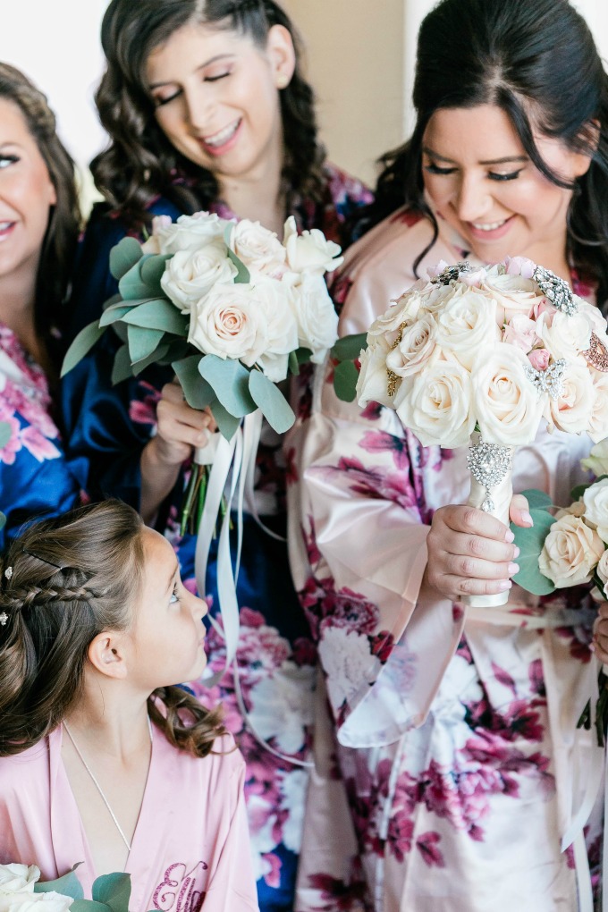 bride looking at flower girl