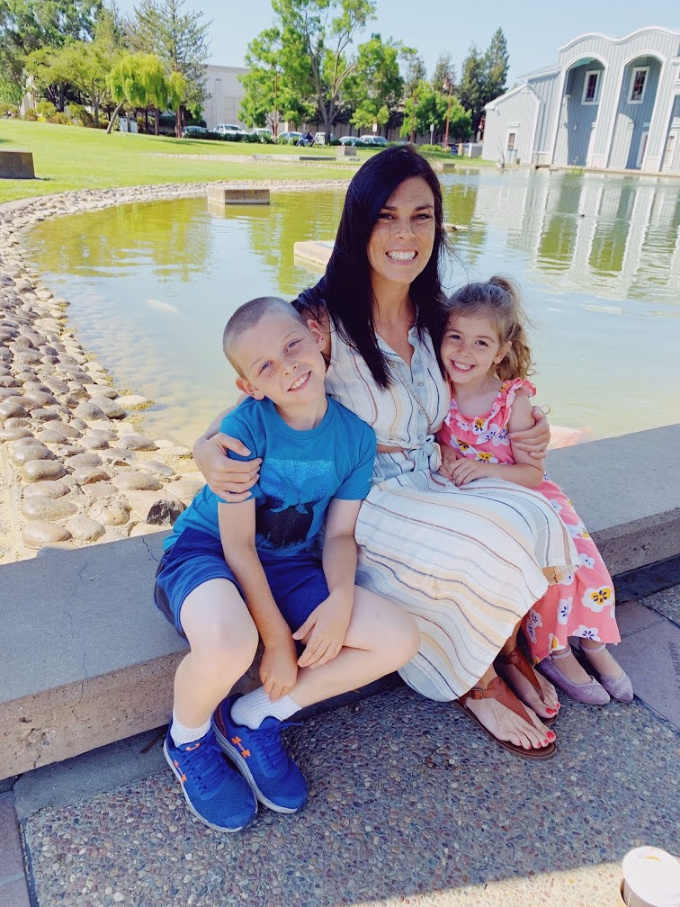 mom with kids sitting by water