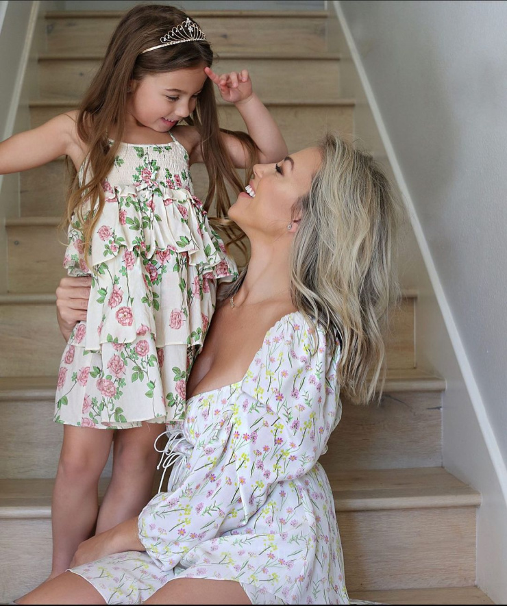 Mom and daughter sitting on the stairs. 