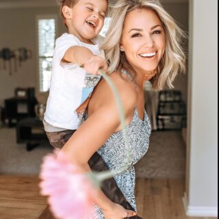 Jessica Hall giving her son a piggy back ride.
