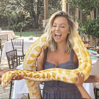 Jessica Hall with a giant white and yellow snake around her neck.