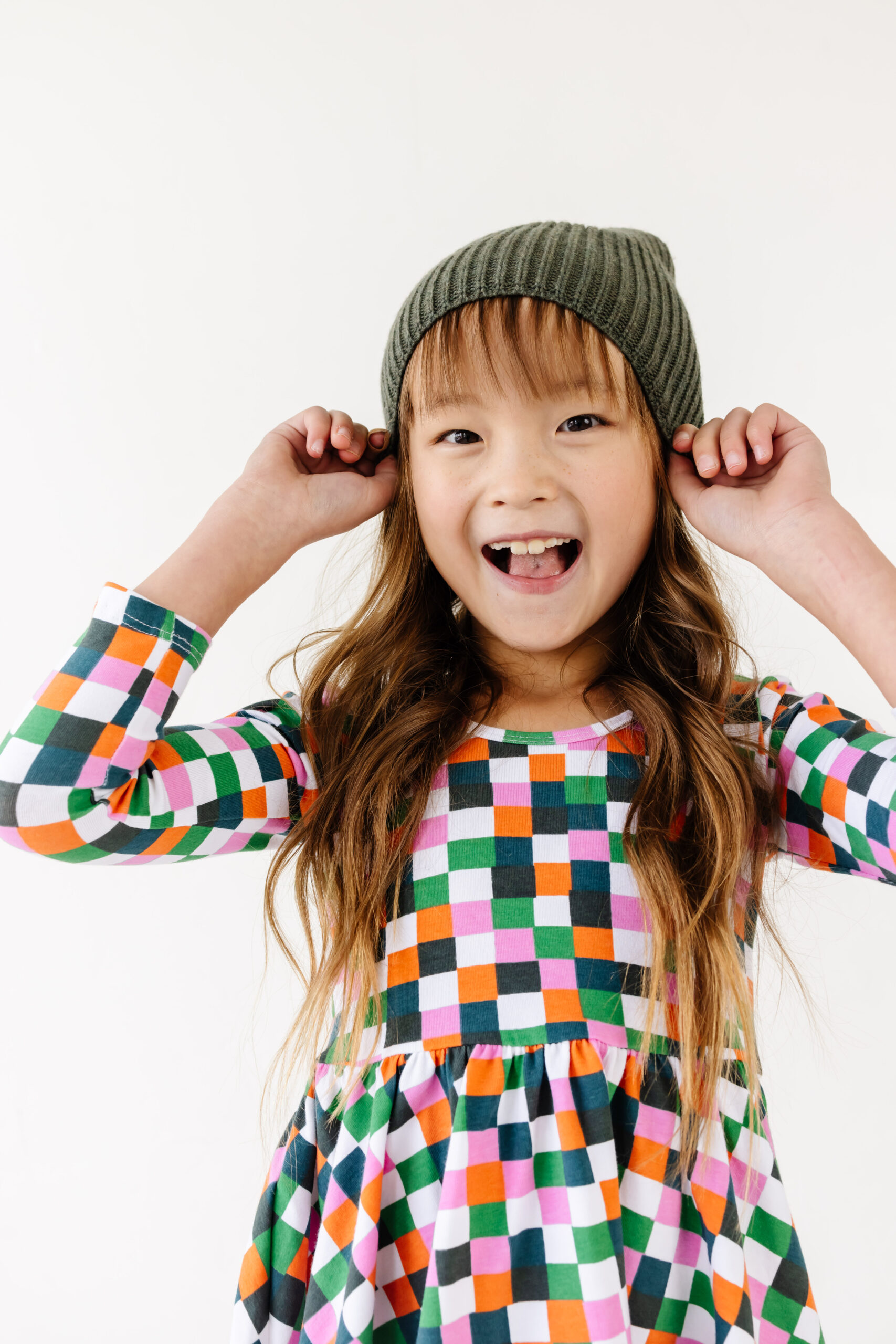 Little Girl wearing a dress and beanie from Alice + Ames.