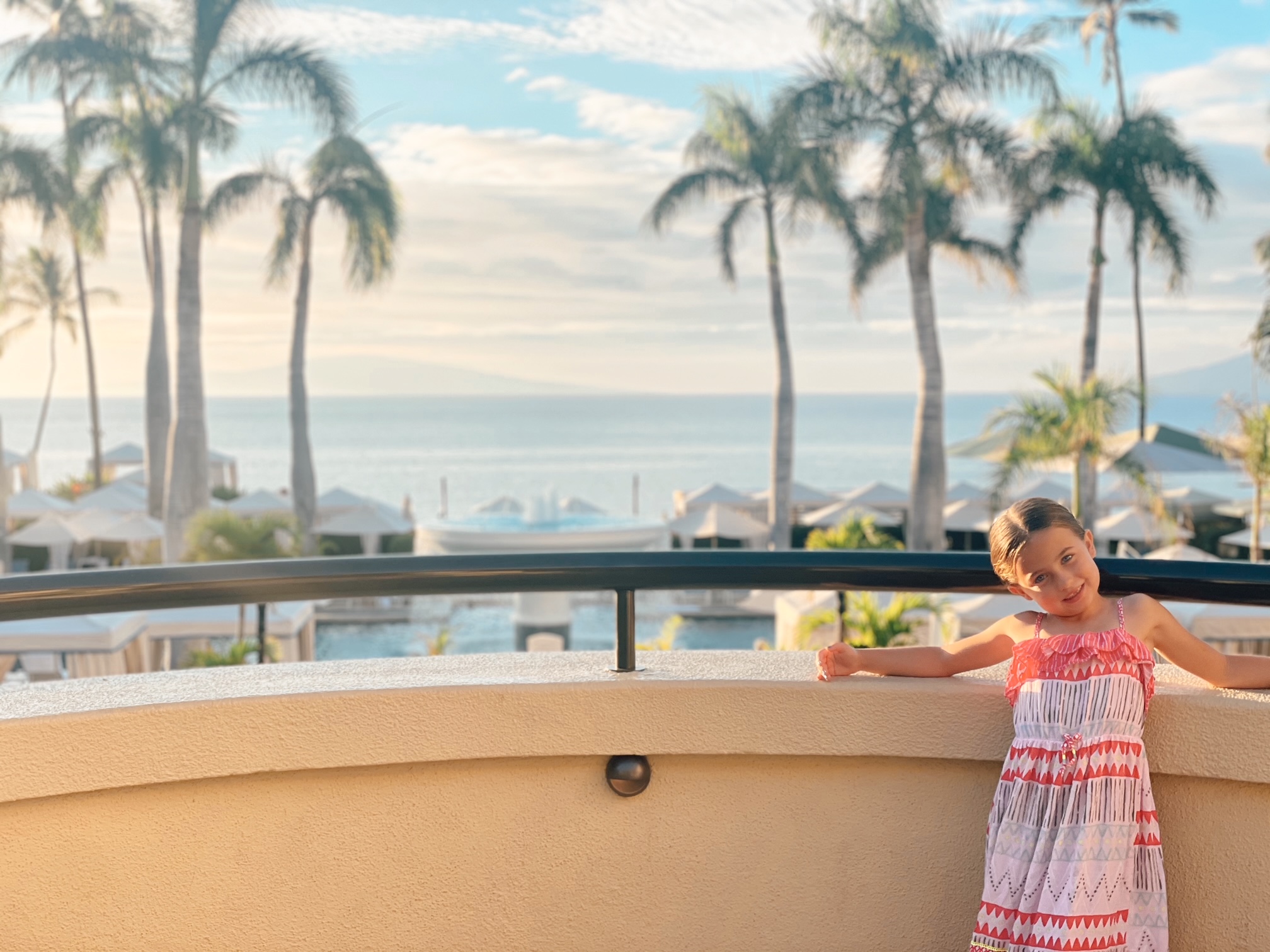 Sophie standing on a balcony at the Four Seasons Resort in Maui.