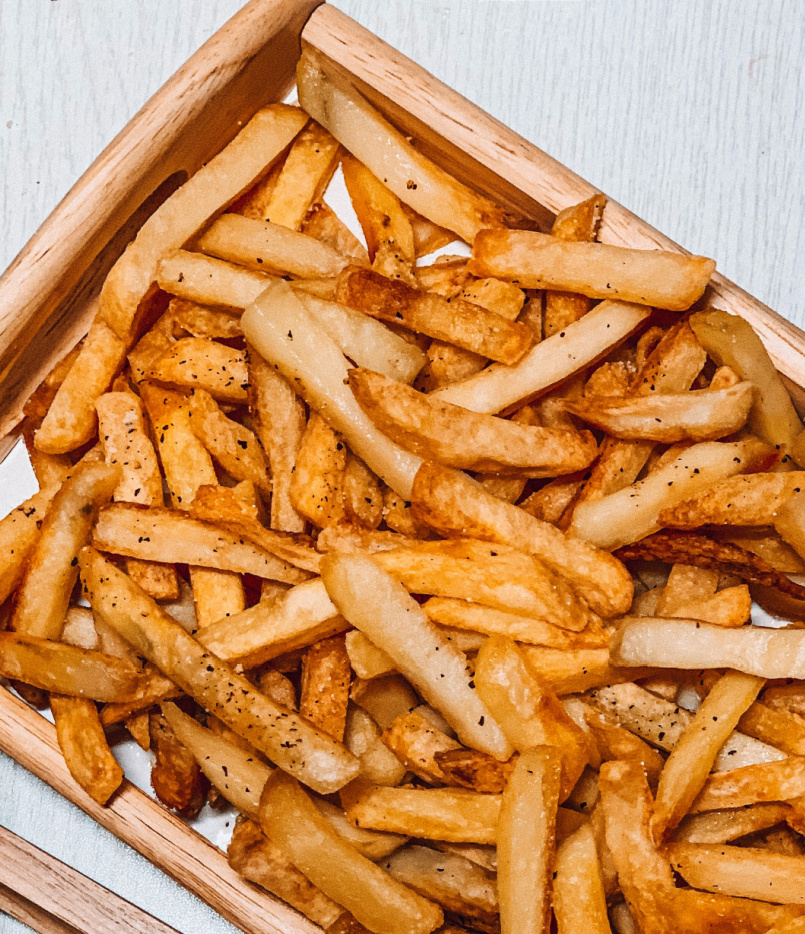 French fries on a wooden tray.
