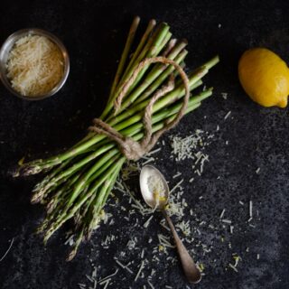 Asparagus with grated cheese and a lemon.