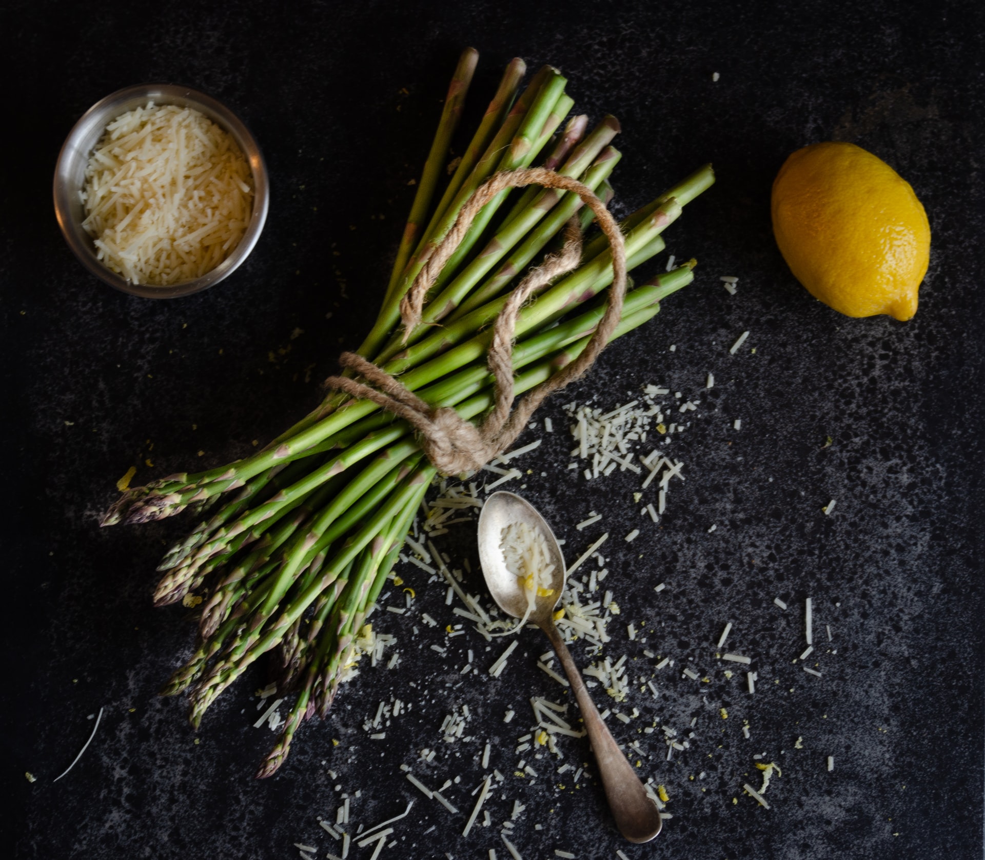 Asparagus with grated cheese and a lemon.