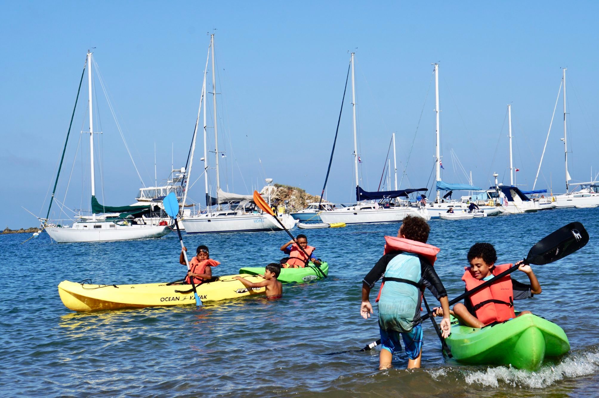 Kids in colorful boats.